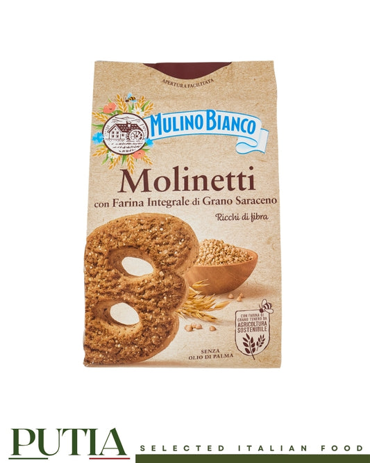 A pack of Mulino Bianco Molinetti biscuits. The rustic paper-like packaging features a large buckwheat shortbread cookie and a bowl of grains, with the text 'Farina Integrale di Grano Saraceno'.